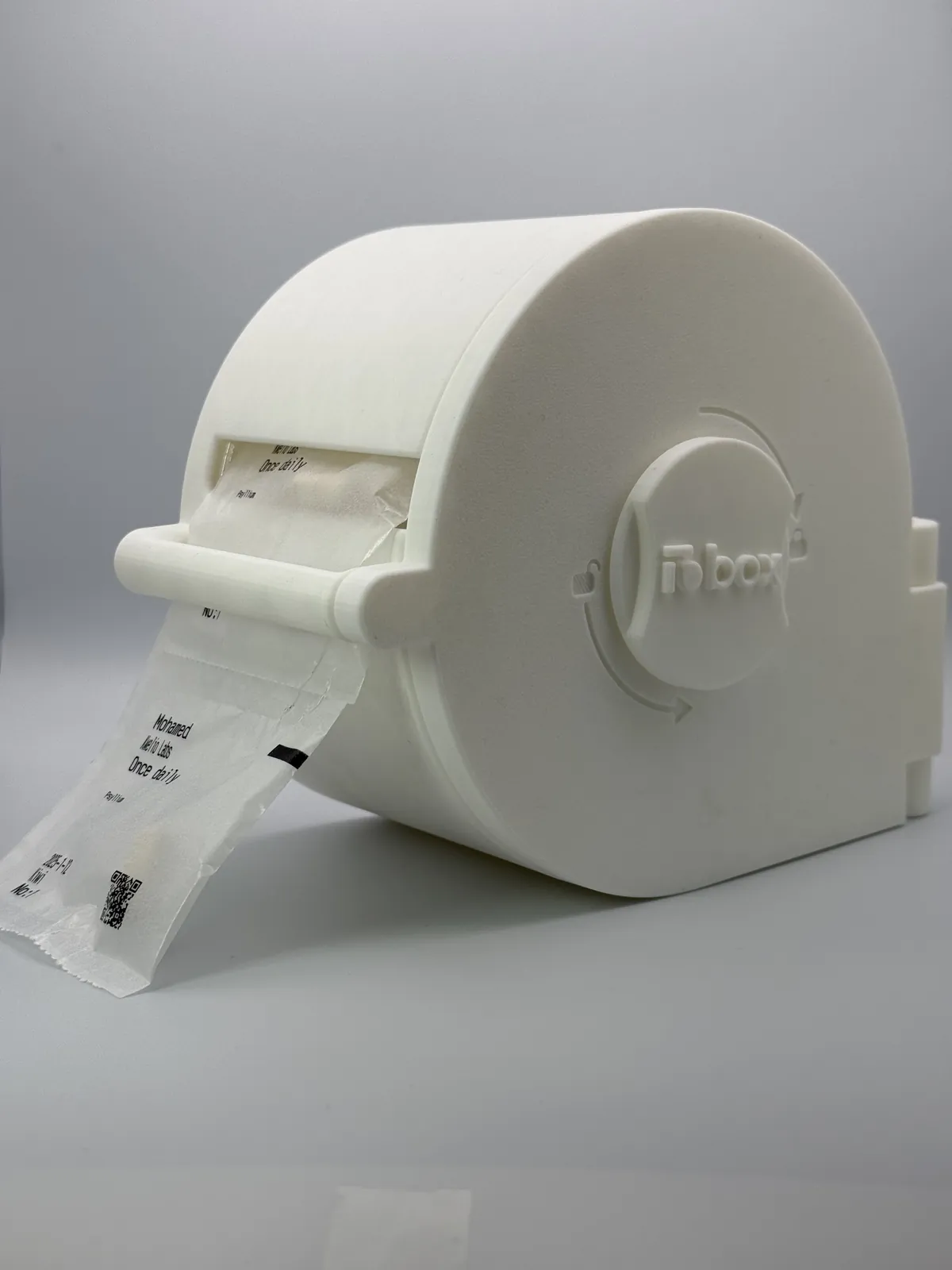 A white LioBox with sealed sachets coming out of its slot