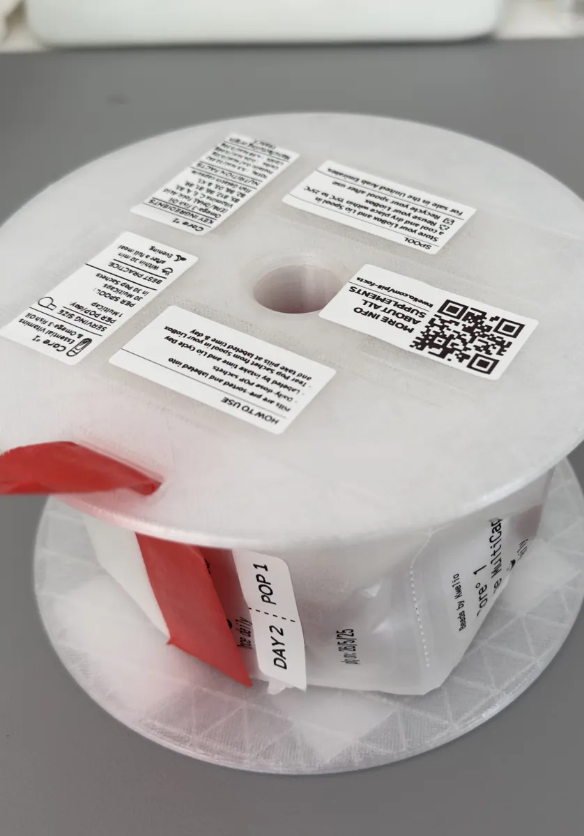 A refill spool of sachets, each printed with its day and Pop number
