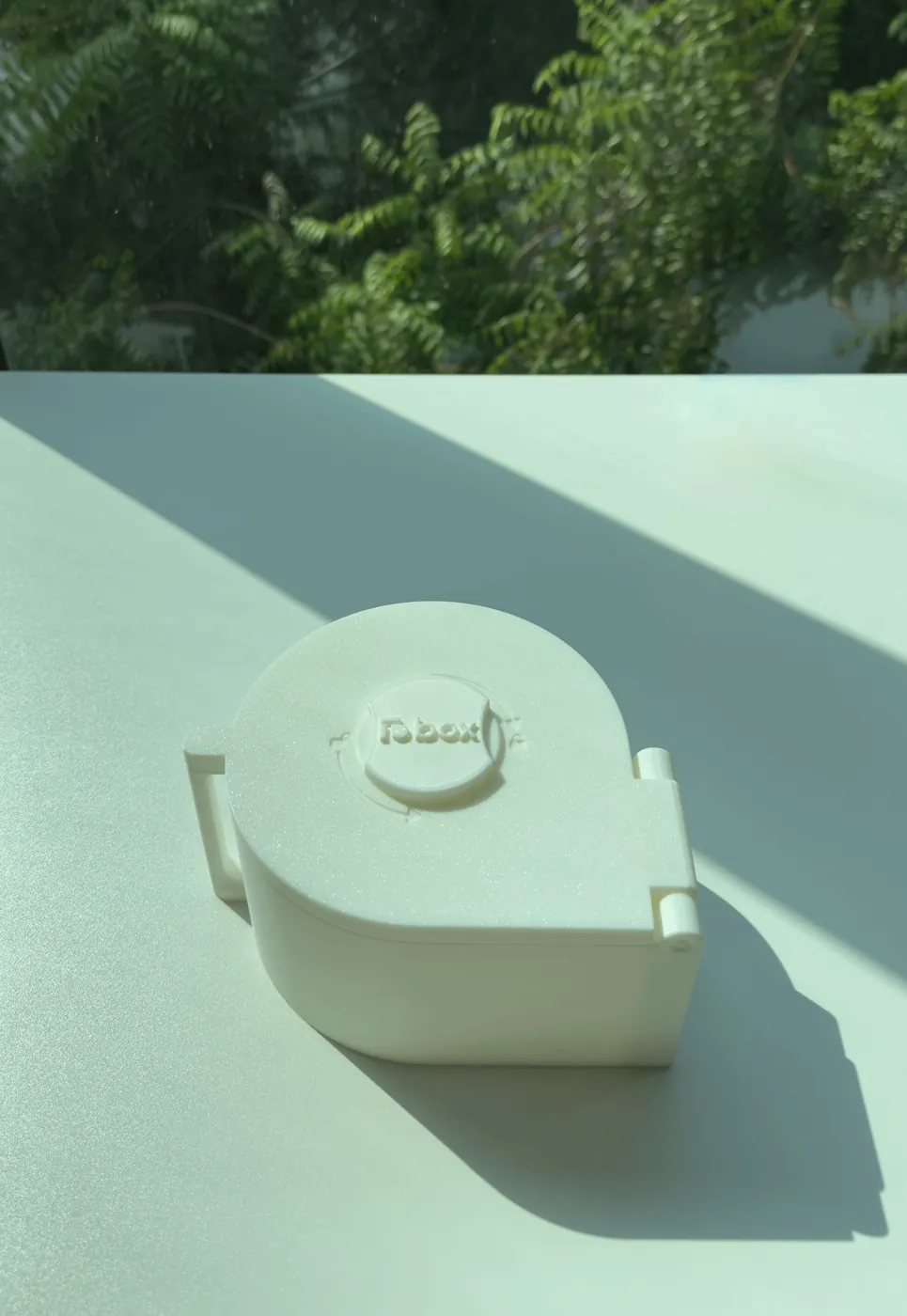 The original LioBox dispenser on a sunlit table