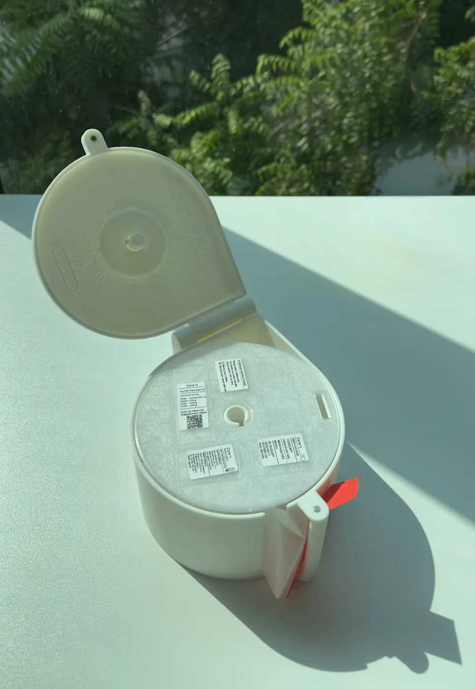 A loaded LioBox with sachets coming out of the front slot